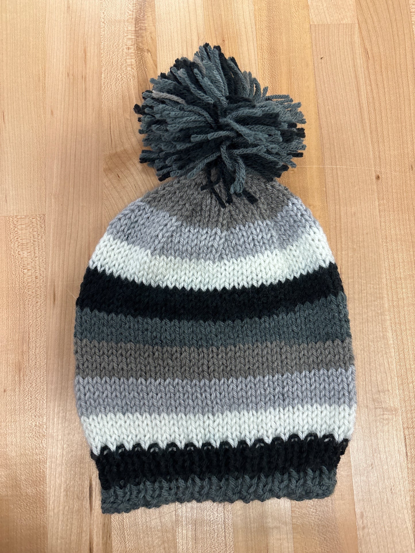 Hand knit winter hat with pom-pom