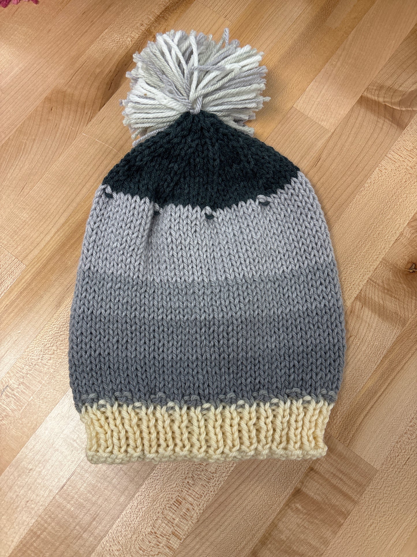 Hand knit winter hat with pom-pom