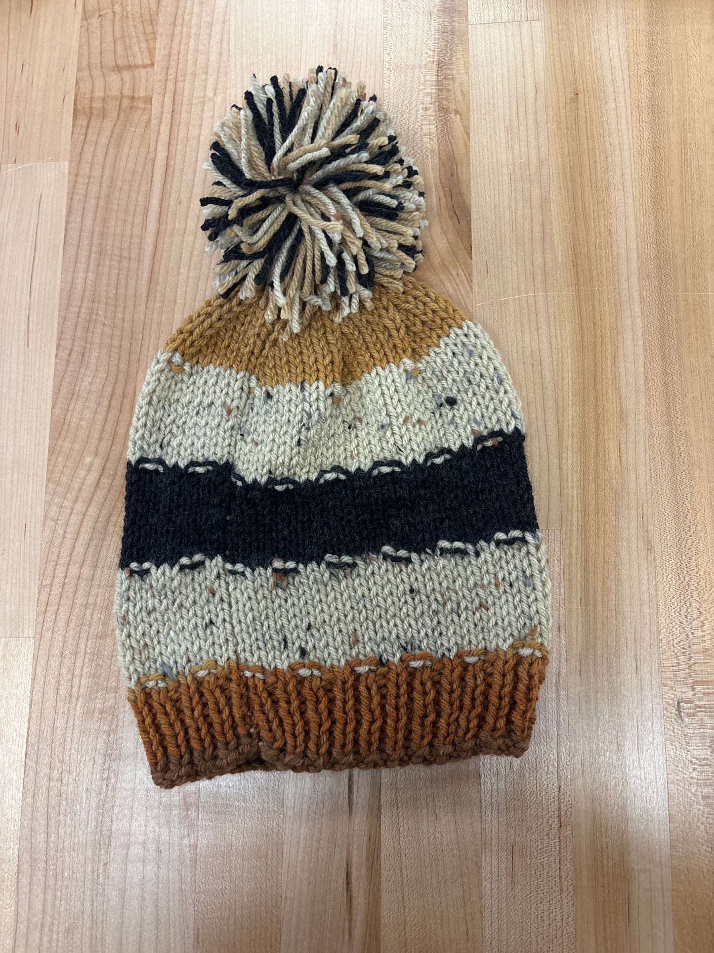 Hand knit winter hat with pom-pom